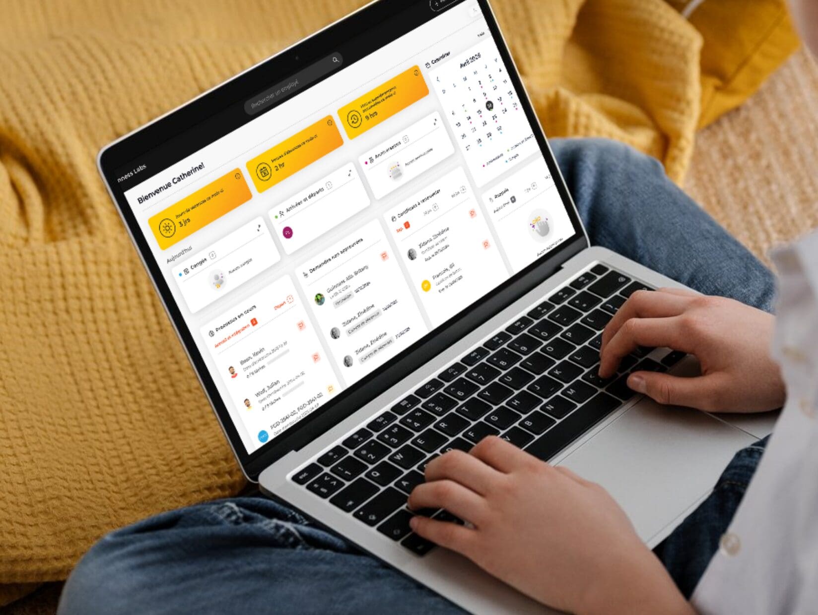 A person sits with a laptop on their lap, interacting with a dashboard-style application that displays tasks, schedules, and reminders in a colorful, organized grid layout.